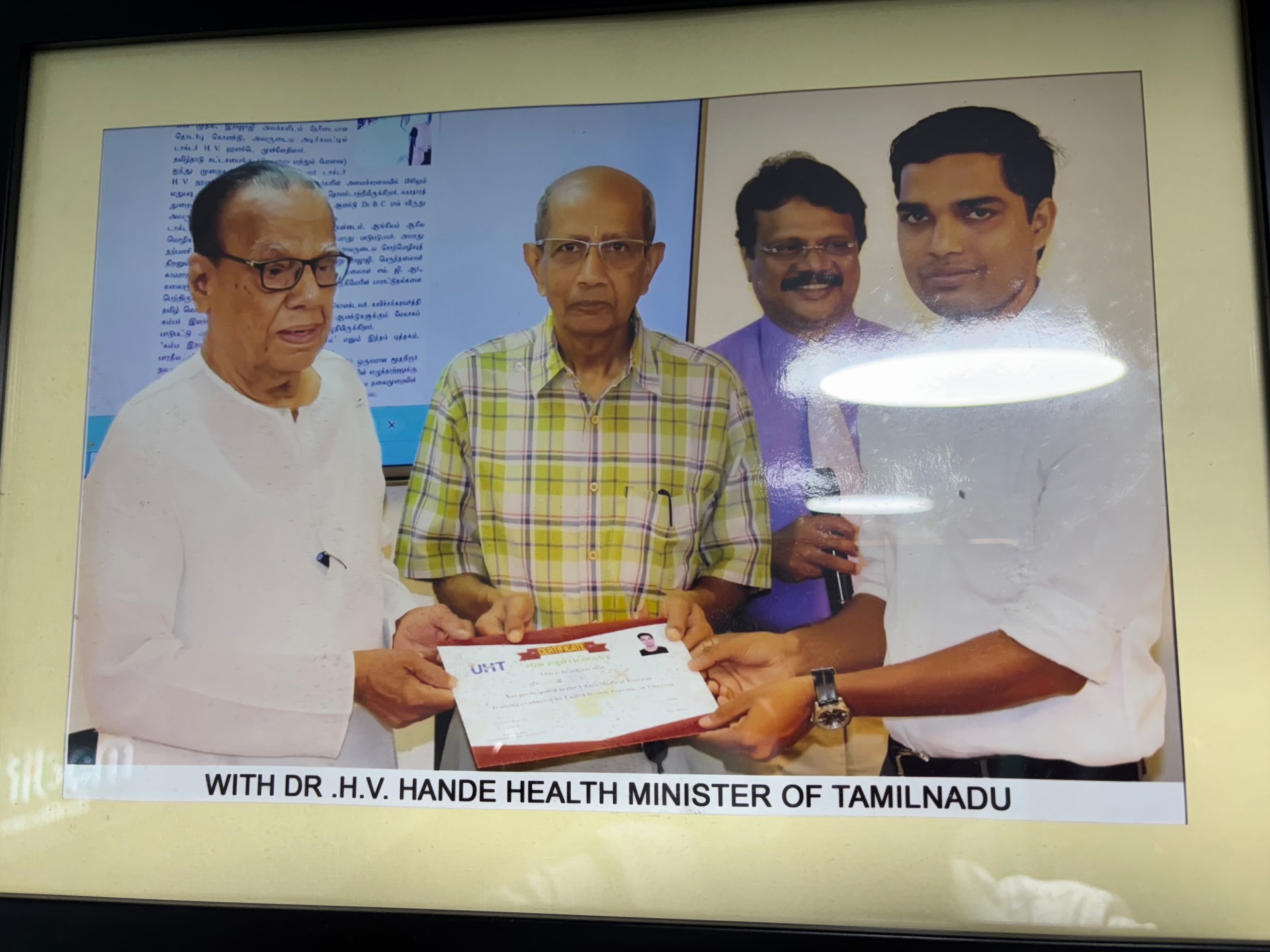 Medifly Healthcare receiving a certificate with Dr. H.V. Hande